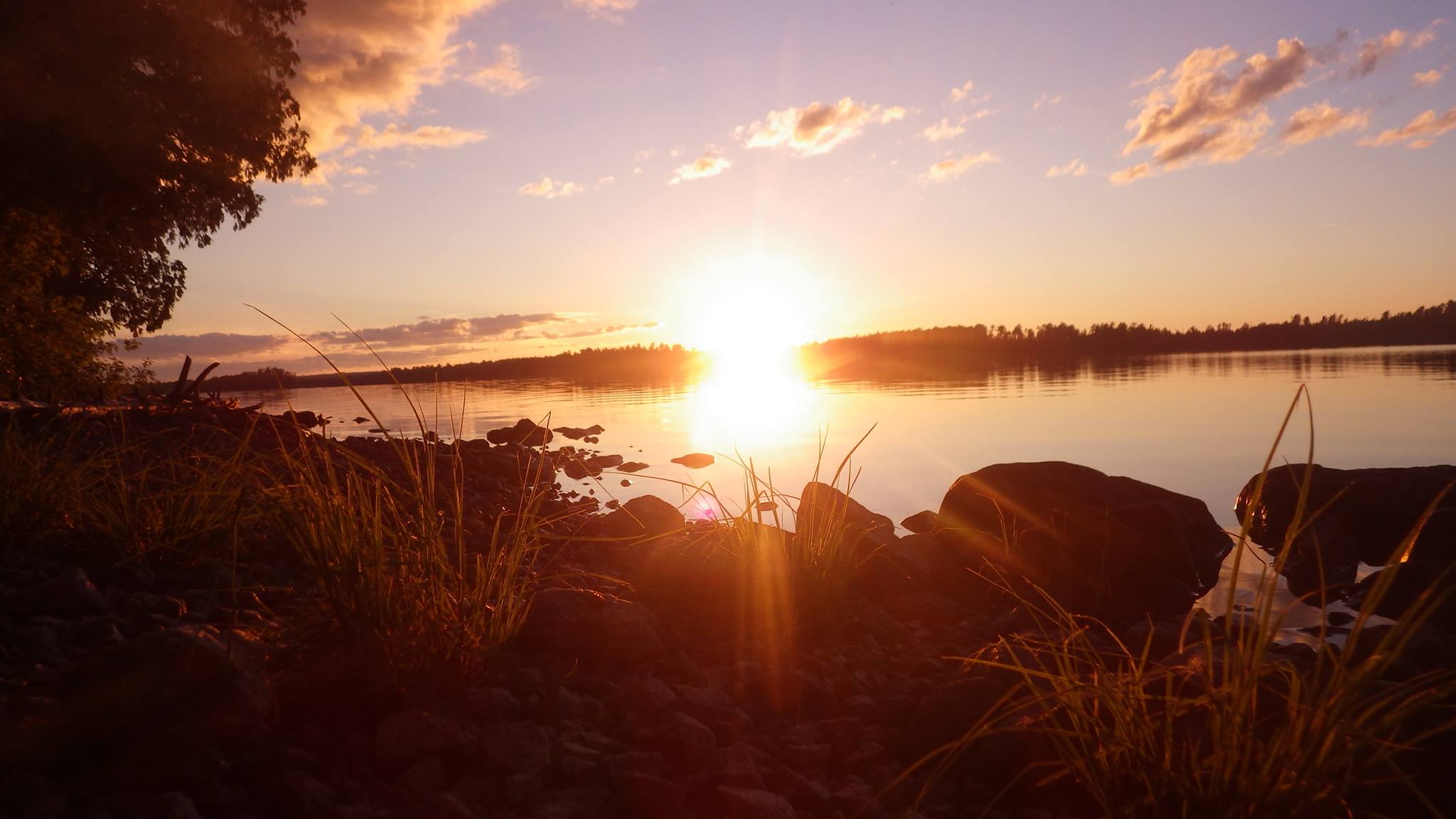 The sun setting over a lake at Northern Tier